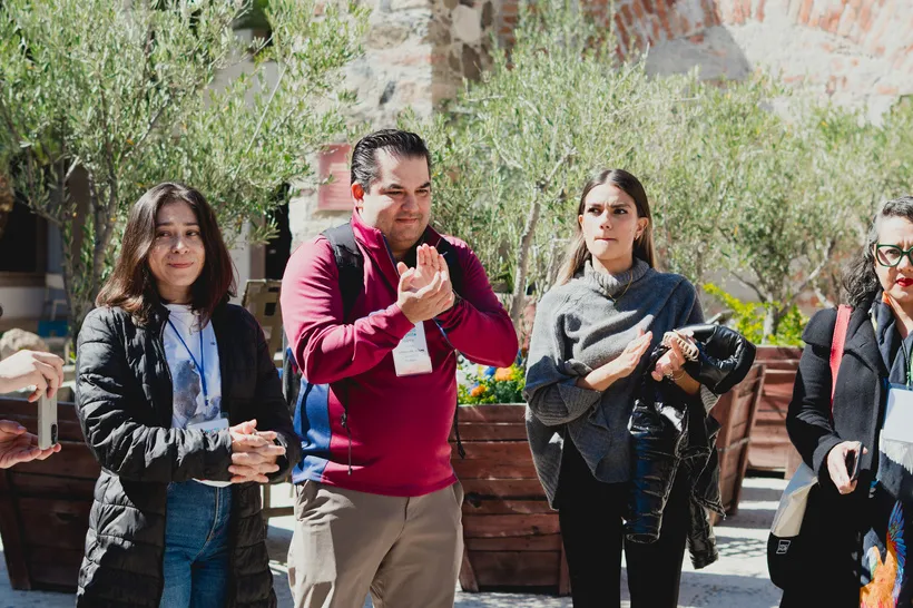 Participantes aplaudiendo durante una actividad al aire libre